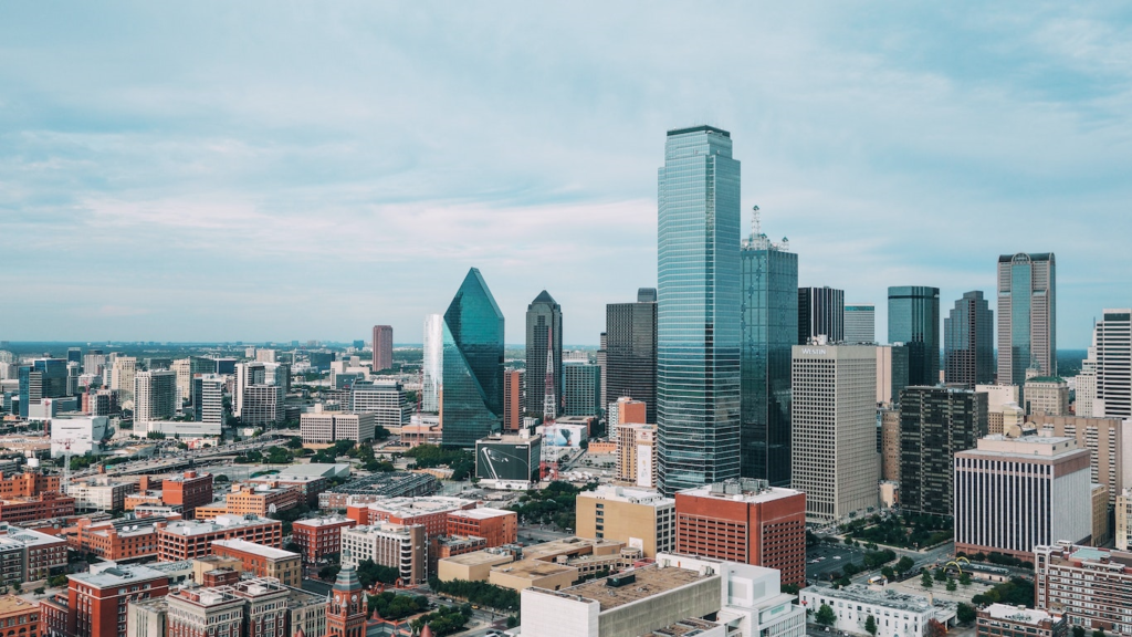 Copier Lease Dallas: Don't Miss Out in 2021 - Aerial view of downtown Dallas, showcasing the cityscape with tall skyscrapers, modern architecture, and a mix of commercial buildings against a blue sky.